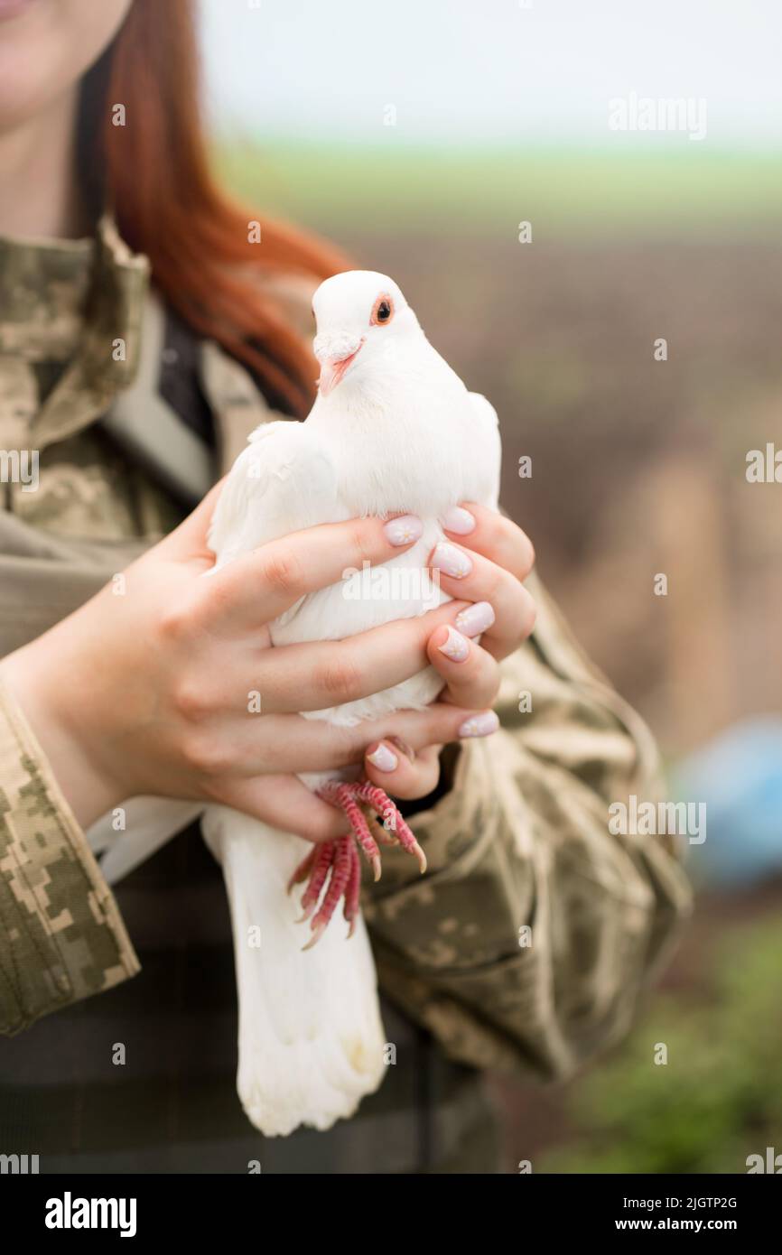 A beautiful Ukrainian young woman in a bulletproof vest with a white