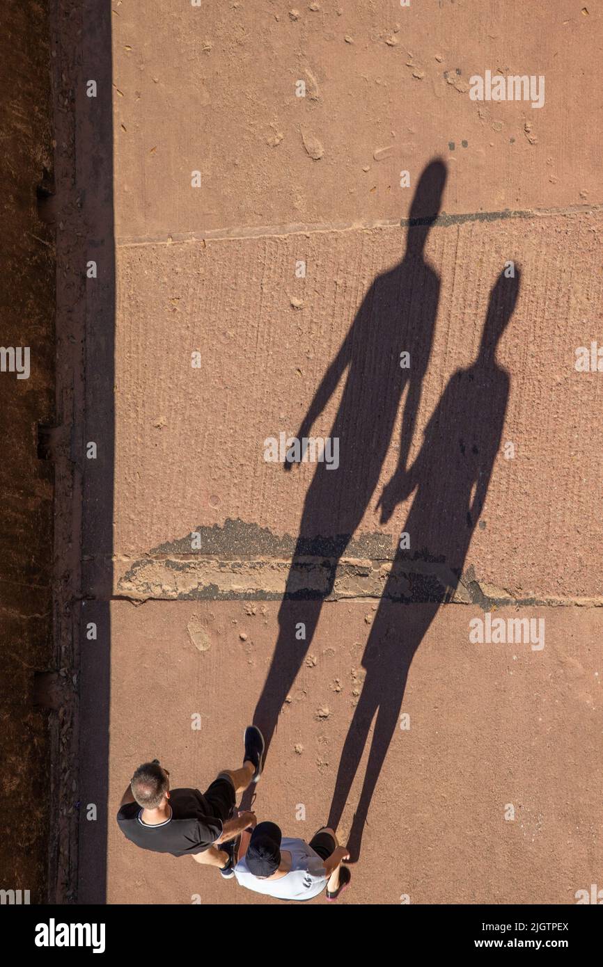 Long shadows of people holding hands Stock Photo Alamy