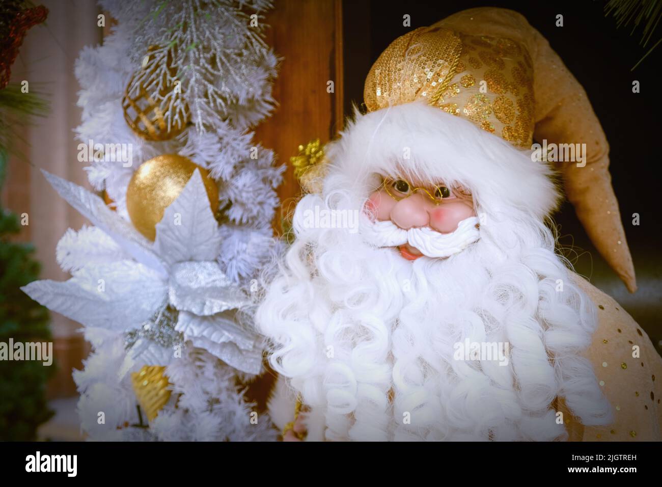 Stylish Santa Claus portrait wearing Christmas yellow-golden costume in retro style and fabulous white beard  Stock Photo