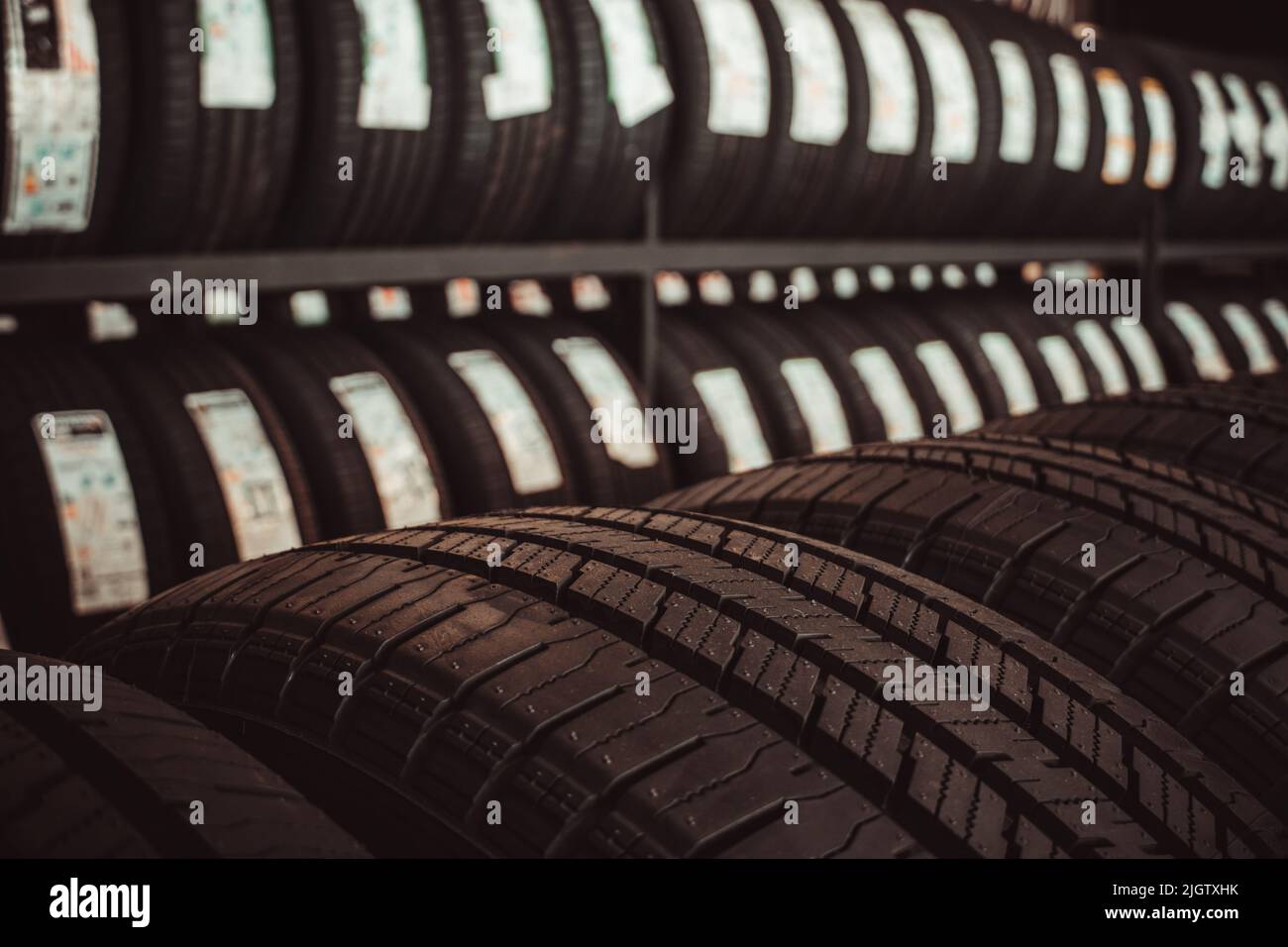 New tires on the shelves of tire service workshops. Stock Photo