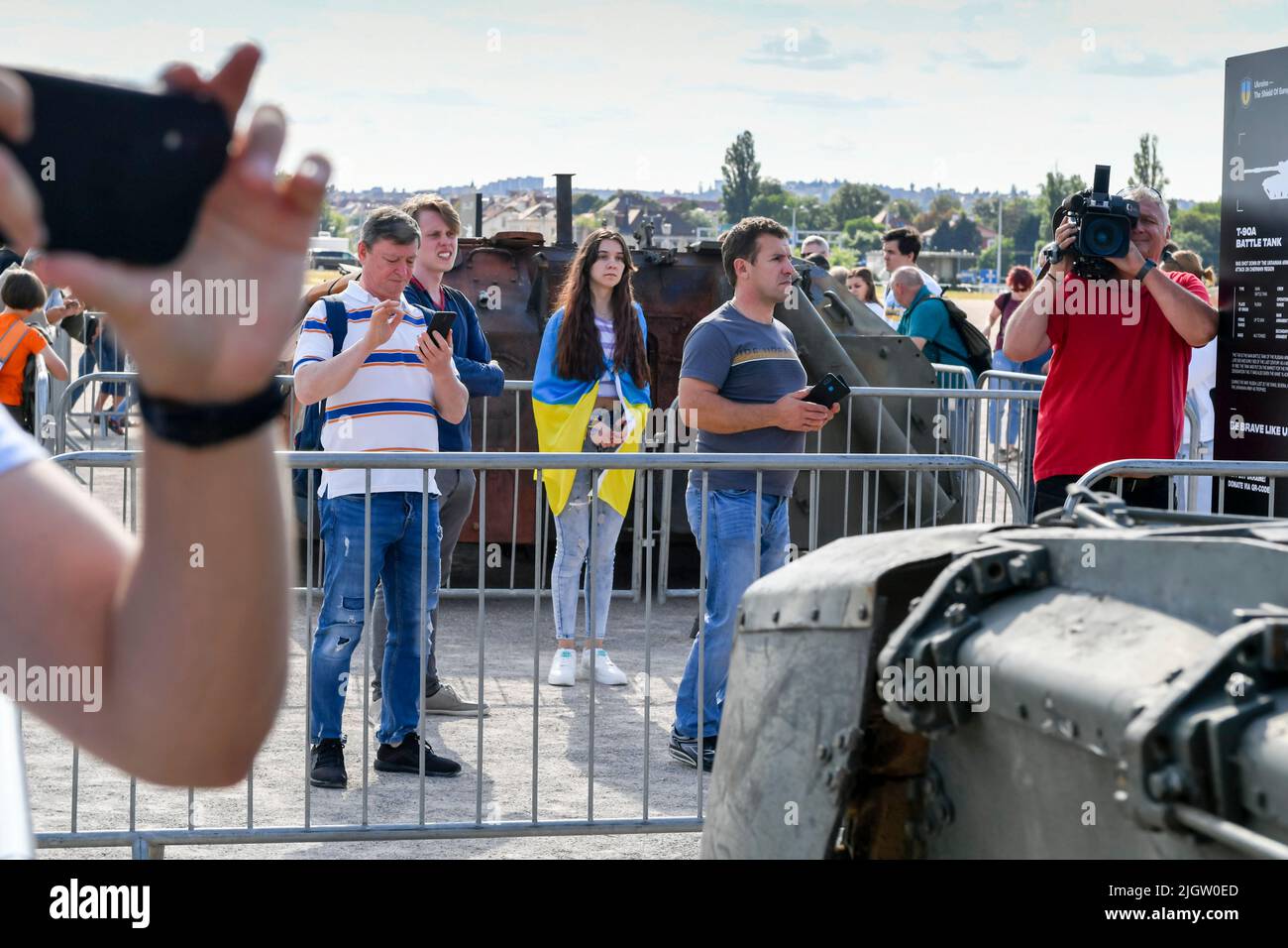 Ukraine girl with flag on exhibition of disabled russian military equipment in ukraine - russian war in Prague. Stock Photo