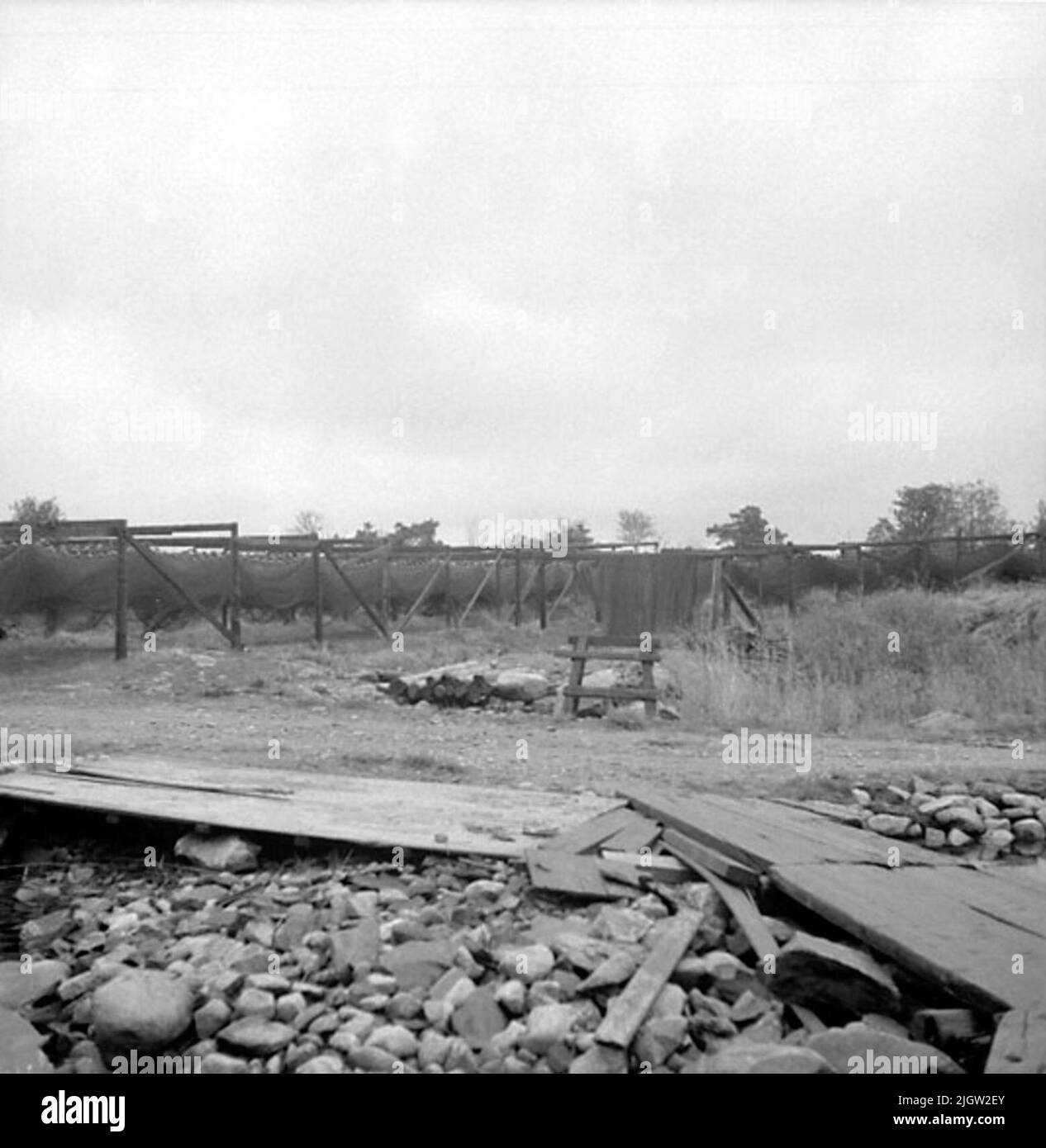 Fishing gear hangs on a dryer on a plane. In the foreground lies so