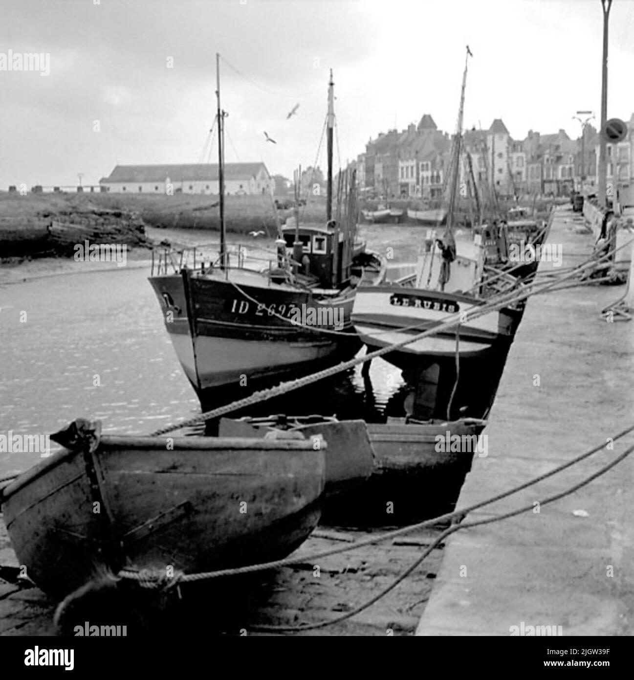 10. France. Photo journal is available at B.M.A. + Photo albums. Acquisition: Books and archive materials. Photos taken 1959-10-17.12 Pictures in series. According to notes: France. Atlantic coast, Le Croisic, 17/10 -59. Boats of different types. Most common and oldest? Seems the boats with aft mirror to be, but boats with hedges or cruise only also occur. The latter appear to have first gained entry among the trawls, while the smaller boats are still clearly dominated by the stern type. A number of boats are in a port. In the background is a society. Stock Photo