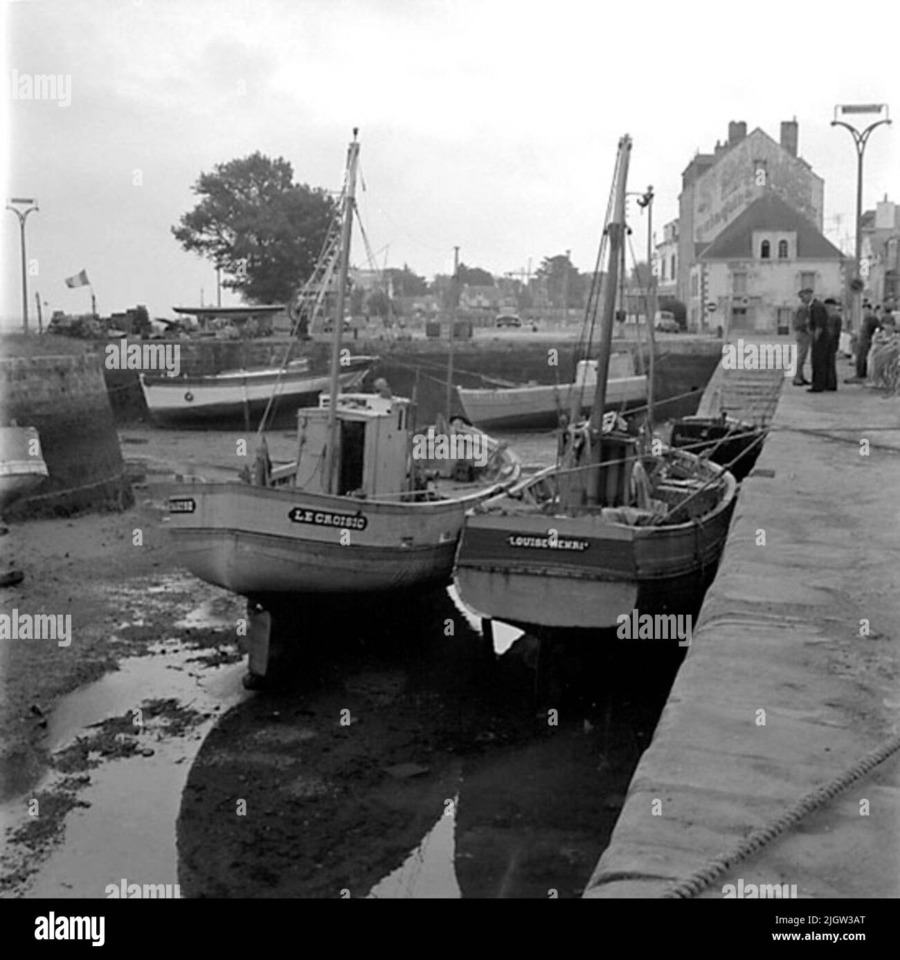 10. France. Photo journal is available at B.M.A. + Photo albums. Acquisition: Books and archive materials. Photos taken 1959-10-17.12 Pictures in series. According to notes: France. Atlantic coast, Le Croisic, 17/10-59. Boats of different types. Most common and oldest? Seems the boats with aft mirror to be, but boats with hedges or cruise only also occur. The latter appear to have first gained entry among the trawls, while the smaller boats are still clearly dominated by the stern type. A number of boats are located in a port in a community. There is low tide, so the boats are at the bottom of Stock Photo