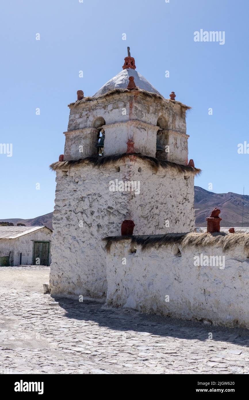 The stone bell tower of the Church of the Virgin of the Nativity in Parinacota on the Andean altiplano in Chile.  Lauca National Park. Stock Photo