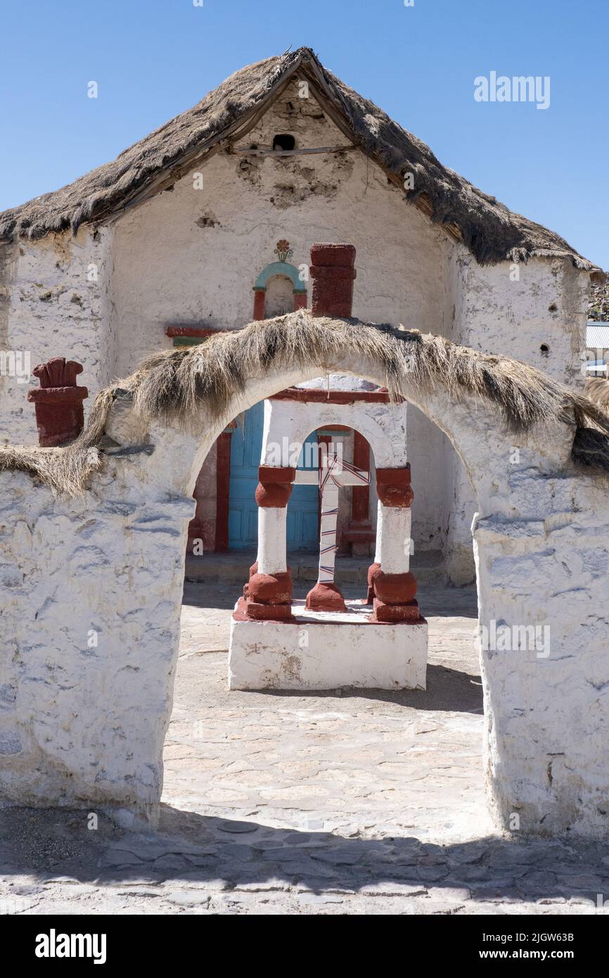 The entry arch and shrine in front of the Church of the Virgin of the Nativity in Parinacota on the Andean altiplano in Chile.  Lauca National Park. Stock Photo