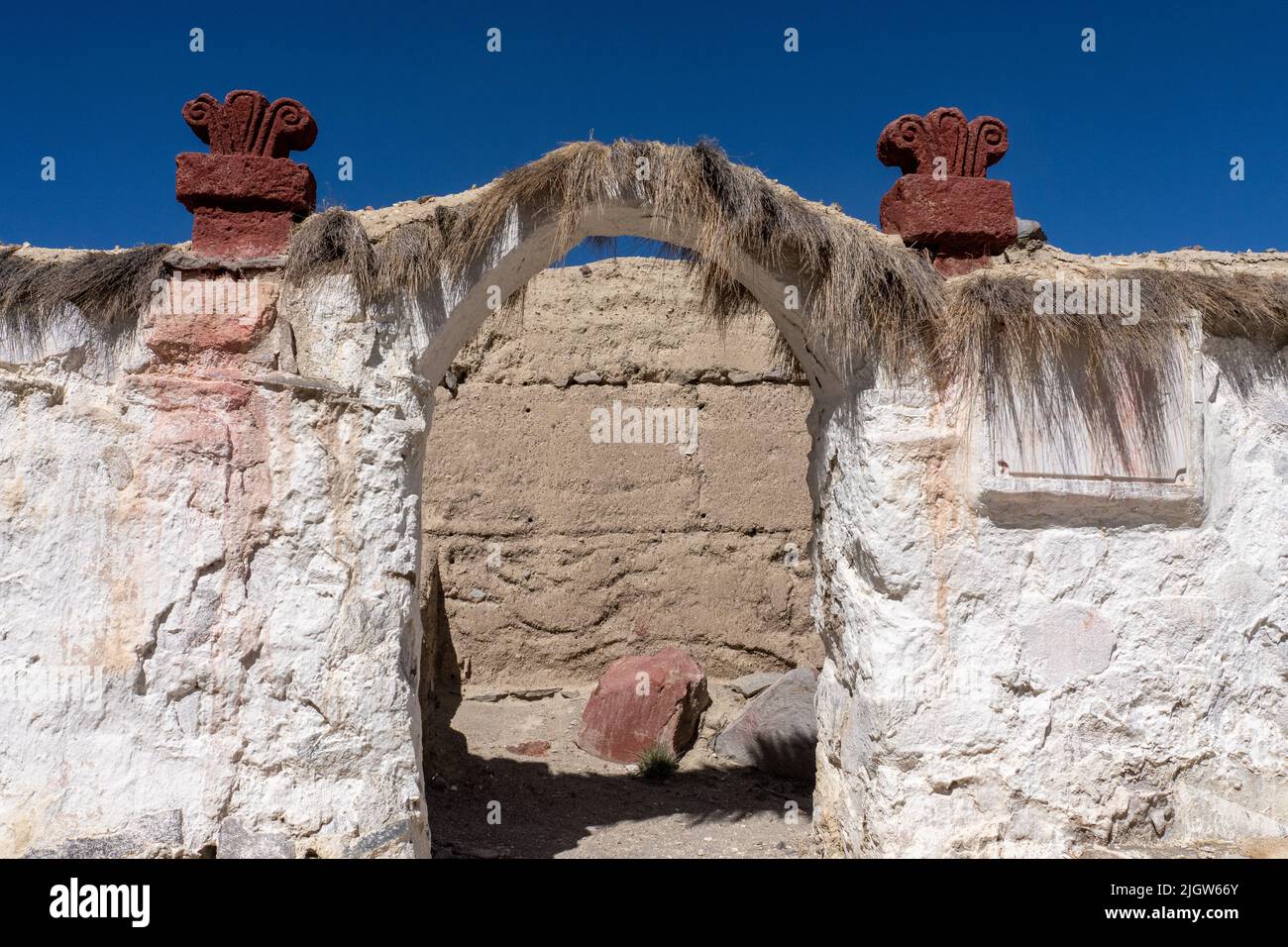 An arched entryway into the grounds of the Church of the VIrgin of the Nativity in the village of Parinacota in Chile. Stock Photo