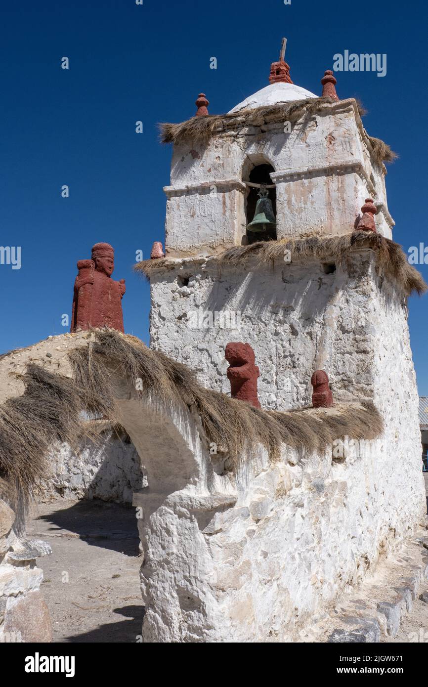 The stone bell tower of the Church of the Virgin of the Nativity in Parinacota on the Andean altiplano in Chile.  Lauca National Park. Stock Photo