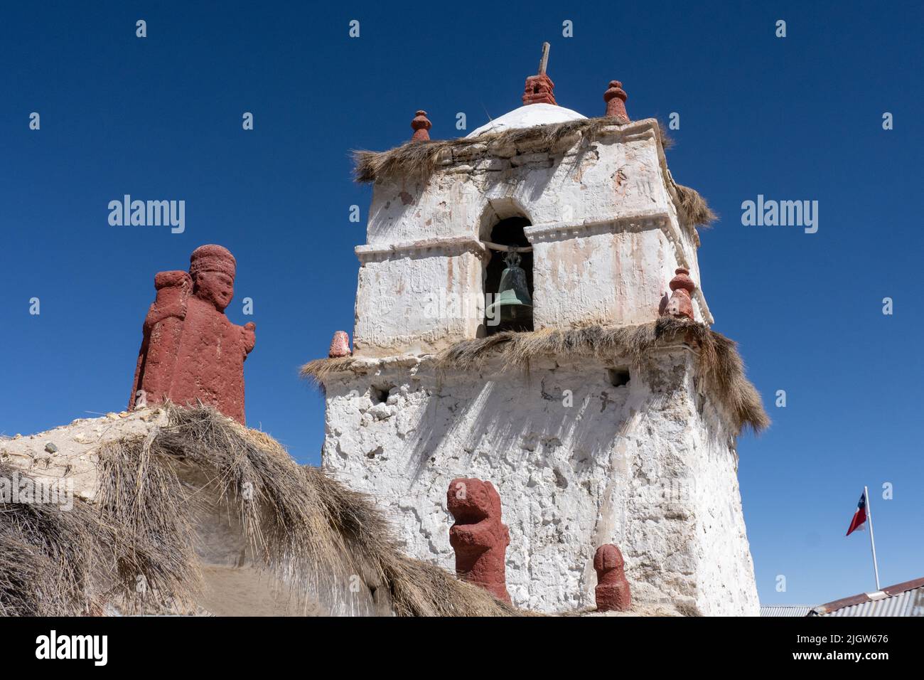 A very old carved stone statue of a bishop over the entry arch to the Church of the Virgin of the Nativity in Parinacota, Chile. Stock Photo