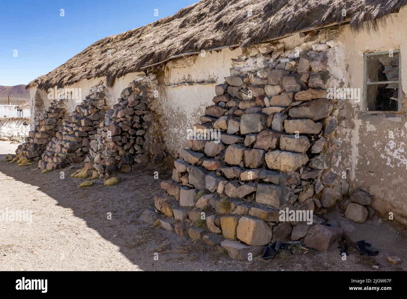 Stone buttresses on the Church of the Virgin of the Nativity in Parinacota on the Andean altiplano in Lauca National Park in Chile. Stock Photo