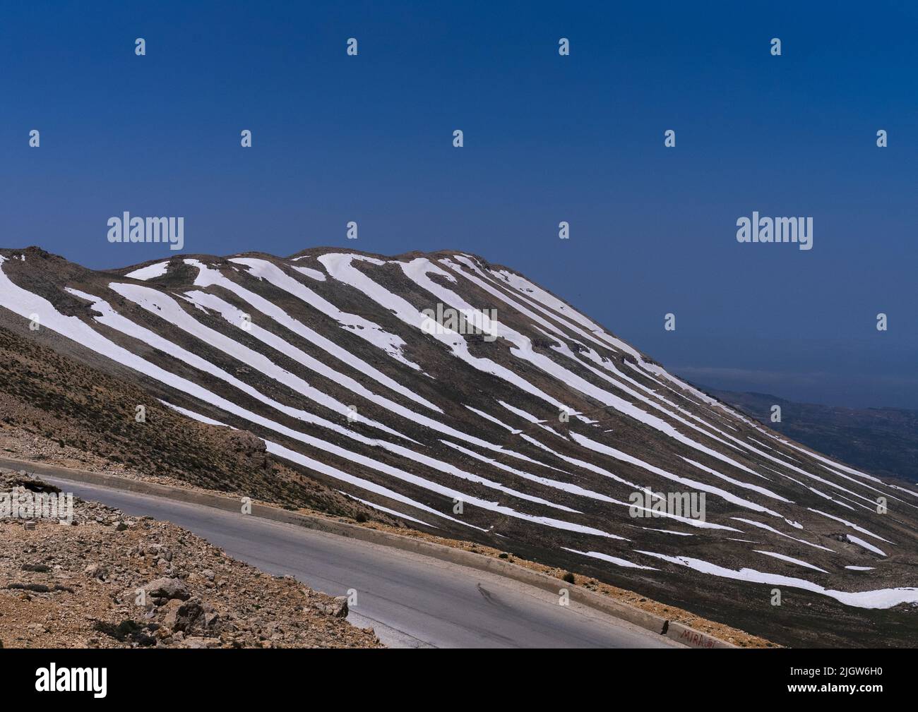 Road in the mountain with patches of snow, North Governorate, Daher el Kadib, Lebanon Stock Photo