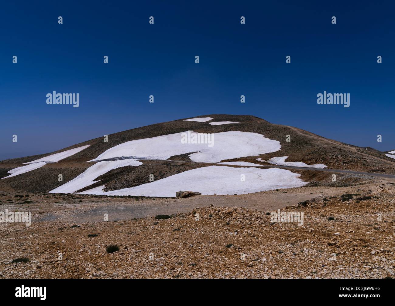 Road in the mountain with patches of snow, North Governorate, Daher el ...