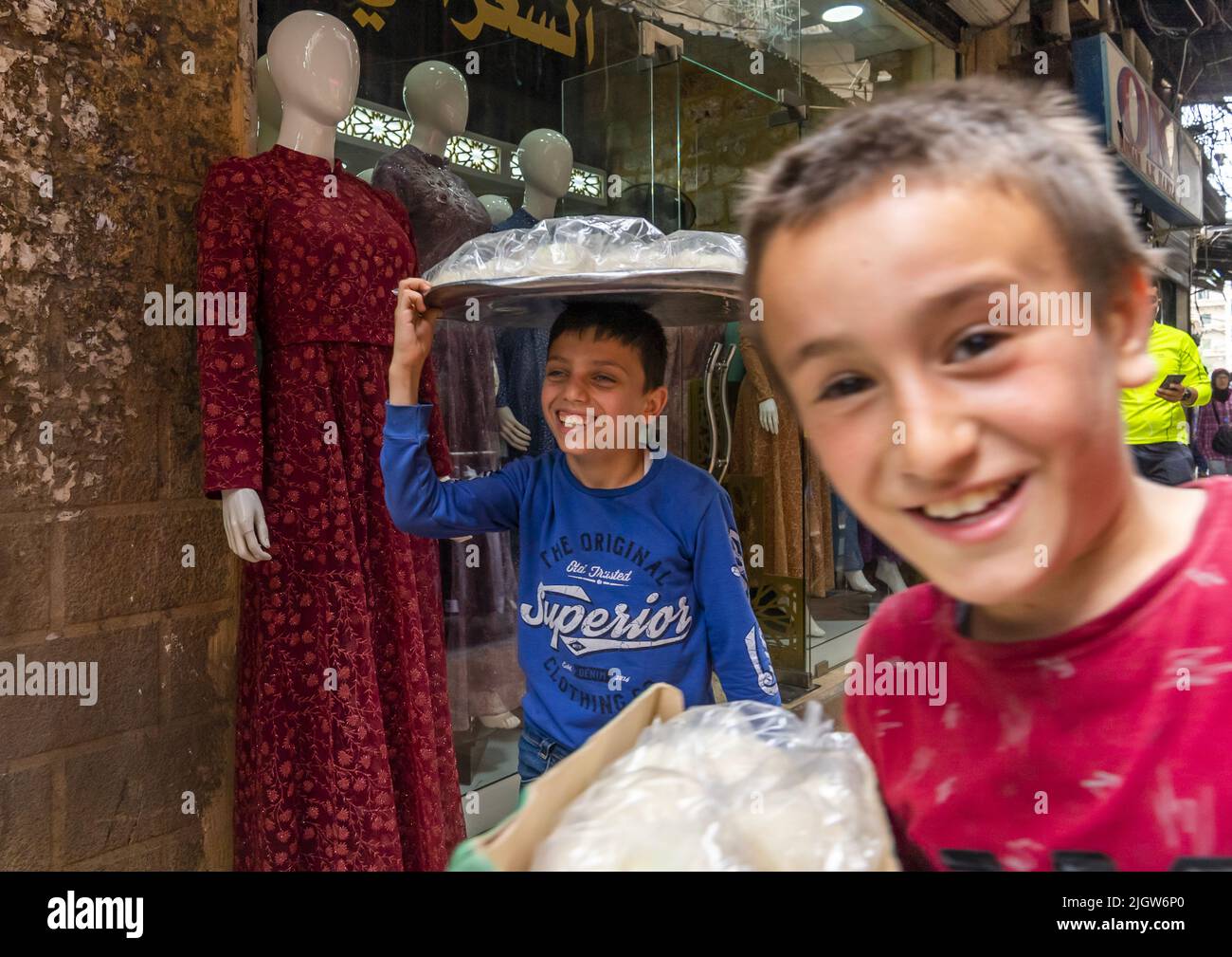 Young syrian boys working in the souk, North Governorate, Tripoli, Lebanon Stock Photo