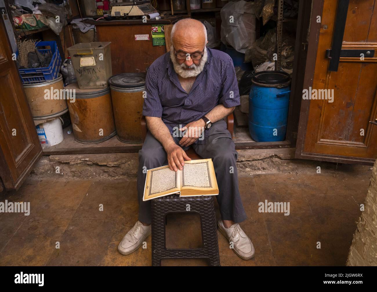 Muslim man reading the quran in the old souk, North Governorate, Tripoli, Lebanon Stock Photo