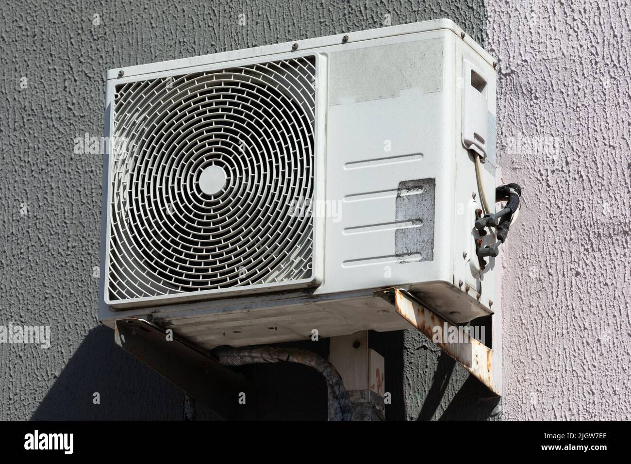 outdoor air conditioner unit with heat exchanger hanging outside the