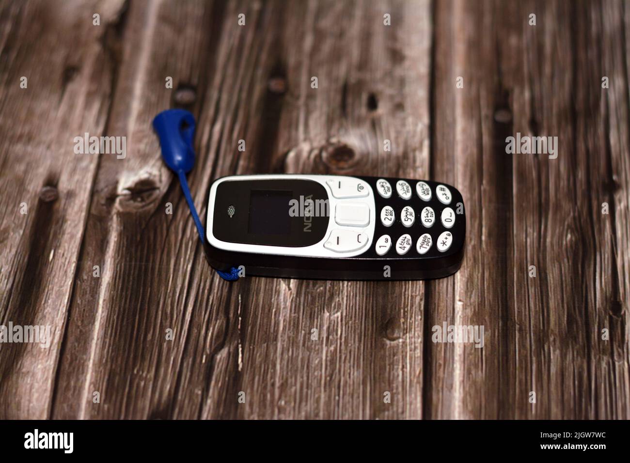 Cairo, Egypt, June 11 2022: A tiny small mini Nokia cell phone, an old classic smart small sized phone with a classic keypad and regular screen isolat Stock Photo