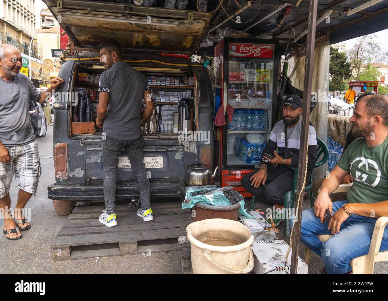 Men having a coffee in the back of a car, North Governorate, Tripoli, Lebanon Stock Photo