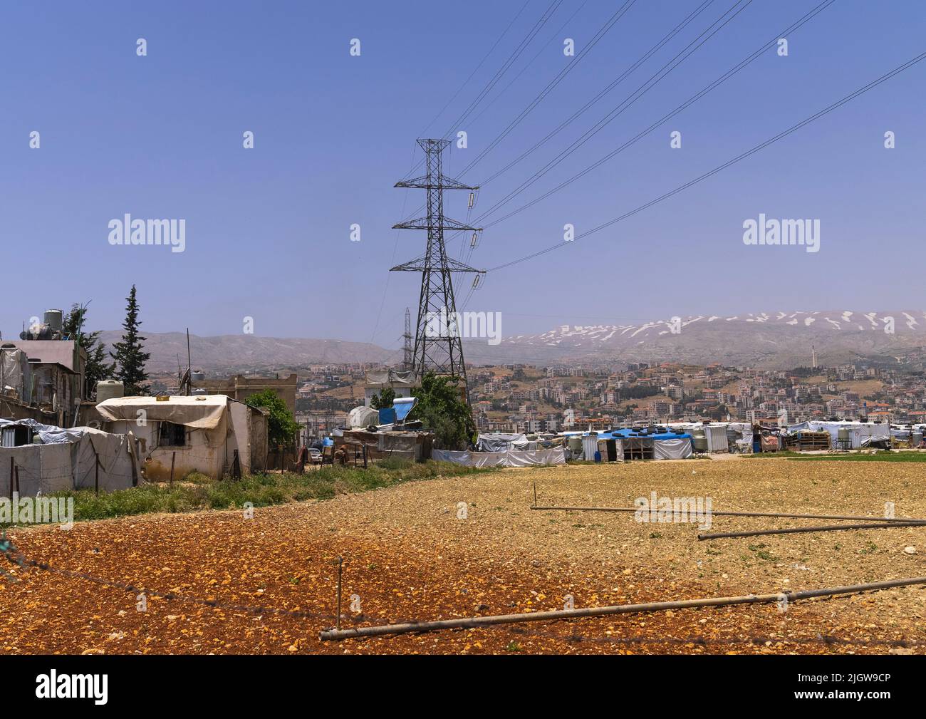 Surian refugees camp under a electric pylon, Beqaa Governorate, Rayak, Lebanon Stock Photo