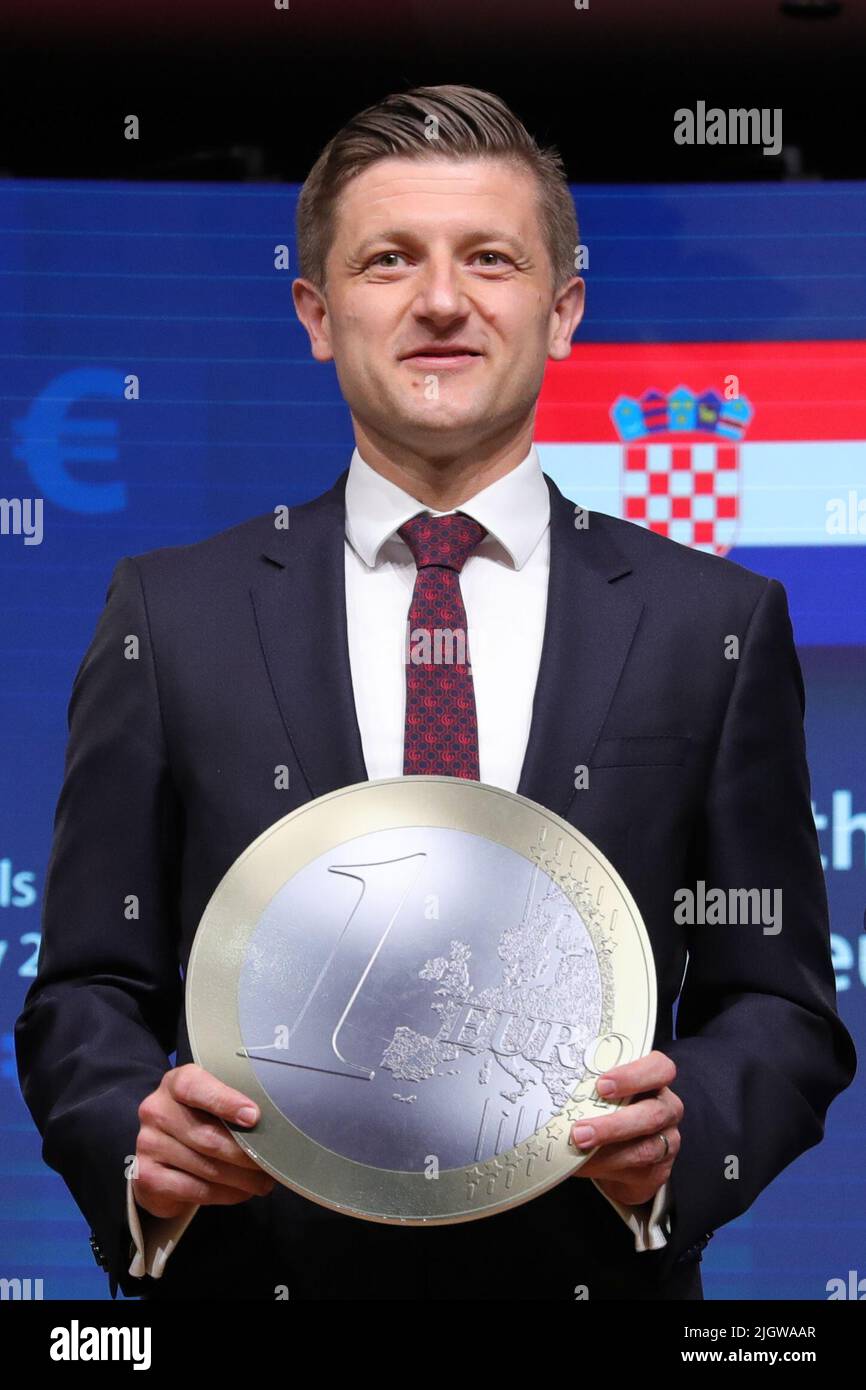 Brussels, July 12. 1st Jan, 2023. Croatian Deputy Prime Minister and Minister of Finance Zdravko Maric poses for a photo holding a model of a euro coin at a signing ceremony on adoption of the euro by Croatia in Brussels, Belgium, July 12, 2022. Croatian Prime Minister Andrej Plenkovic on Tuesday welcomed the decision by the European Union's Economic and Financial Affairs Council (ECOFIN) to integrate Croatia into the eurozone on Jan. 1, 2023. Credit: Zheng Huansong/Xinhua/Alamy Live News Stock Photo