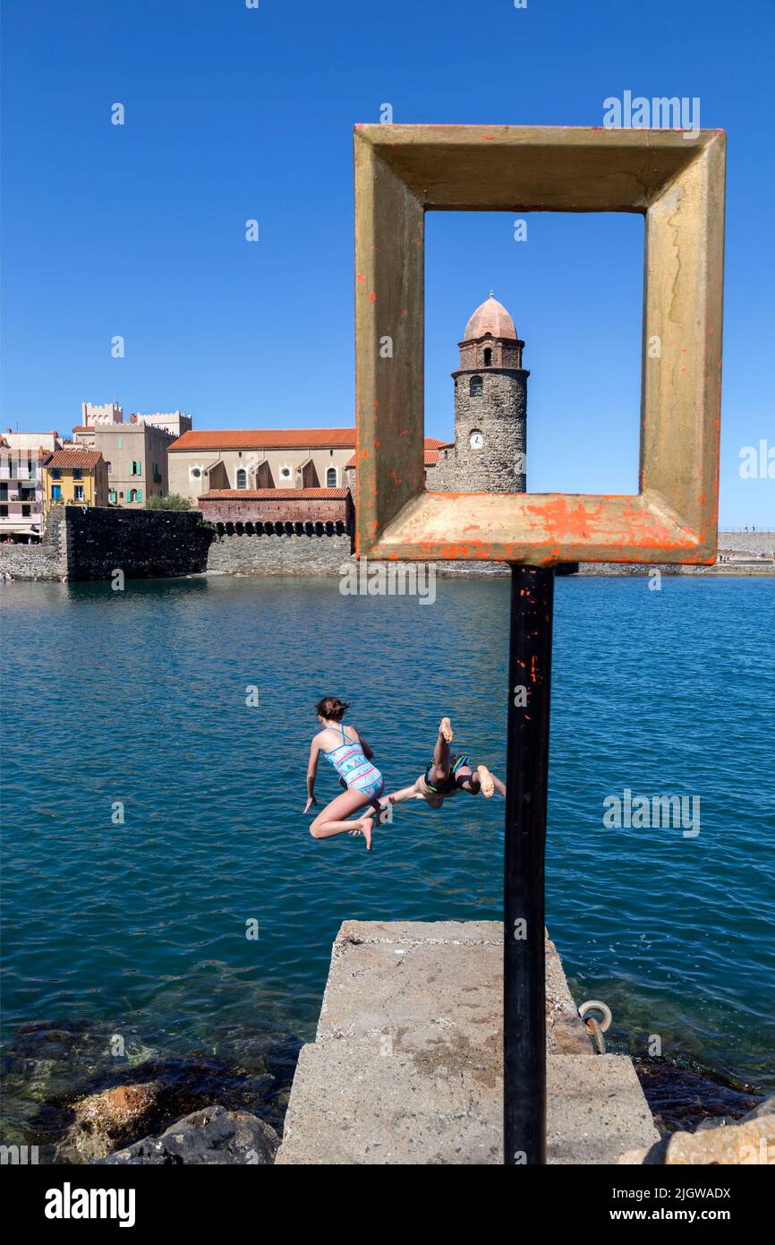 Swimming in front of the Notre-dame-des-Anges Church, Saint-Vincent beach. Collioure, Occitanie, France Stock Photo