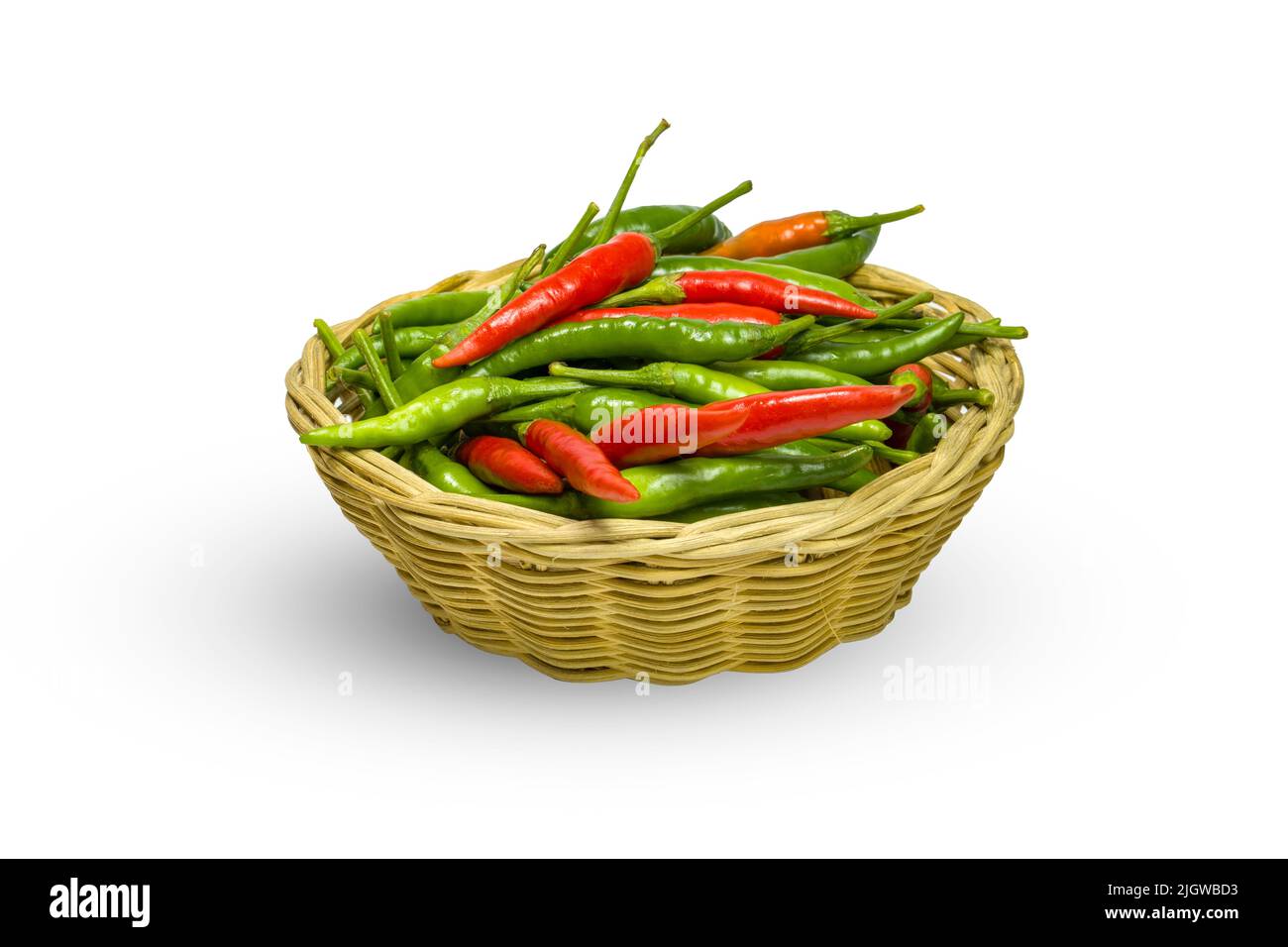 Fresh chili peppers in a basket on white background, chilis are hot and spicy Stock Photo