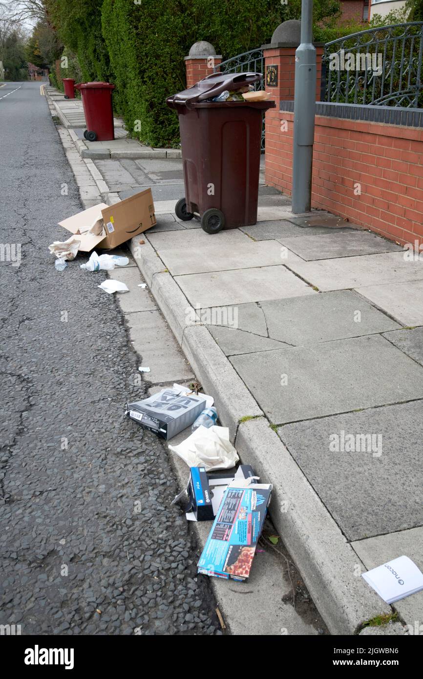 recyclables scattered along pavement litter in the uk Stock Photo