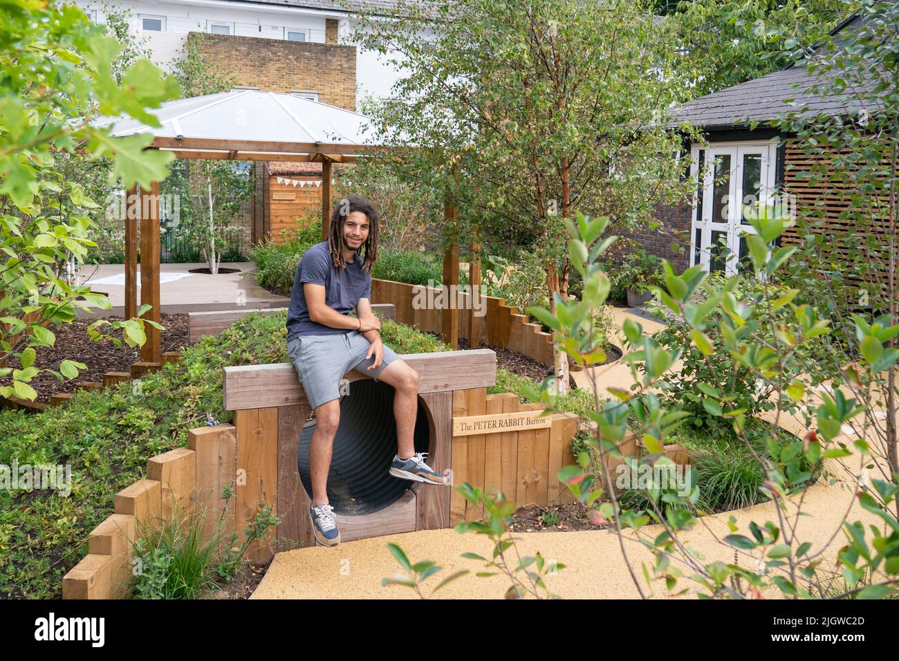 Tayshan Hayden-Smith from Grow2Know at the new 120th anniversary Peter Rabbit garden, built by Grow2Know, an organisation founded in the wake of the Grenfell fire tragedy, at St Clement And St James CE Primary School, in London. Picture date: Wednesday July 13, 2022. Stock Photo