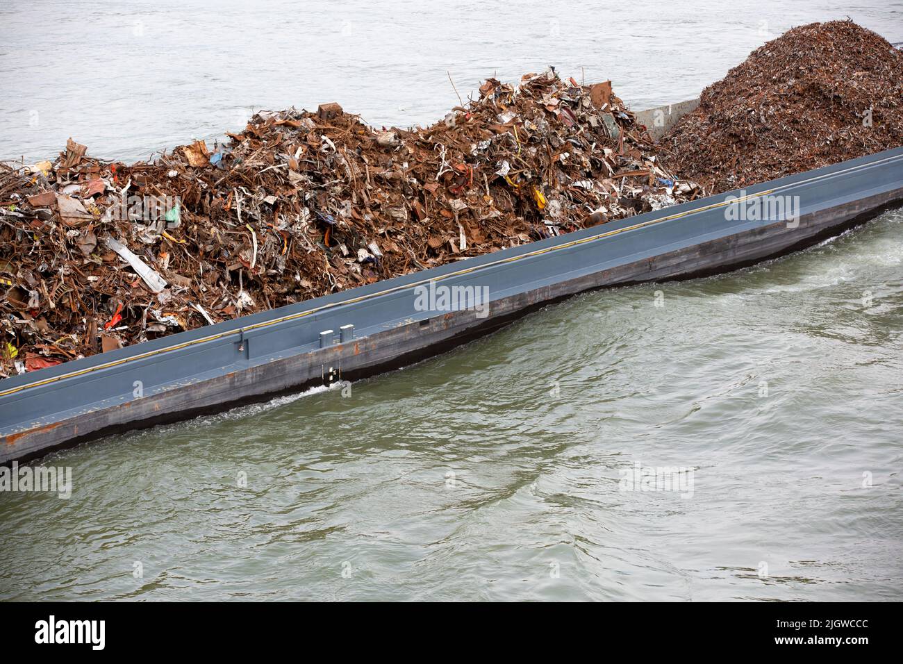 Cargo Ship Loaded With Metal Scrap On A River. Scrap Metal Trade, Scrap