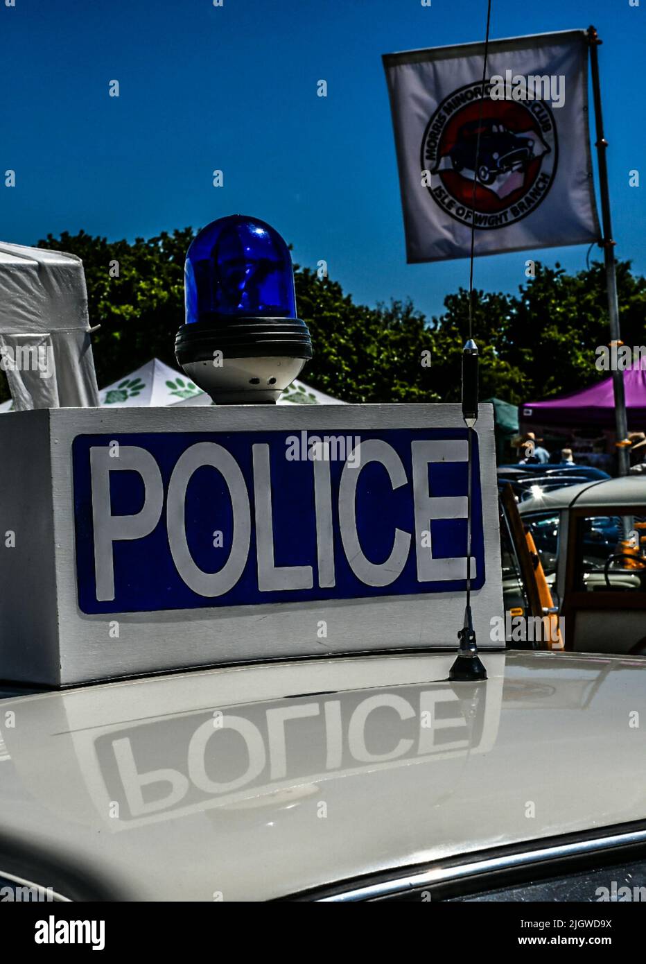 The vertical view of a vintage police car flashing light and sign Stock
