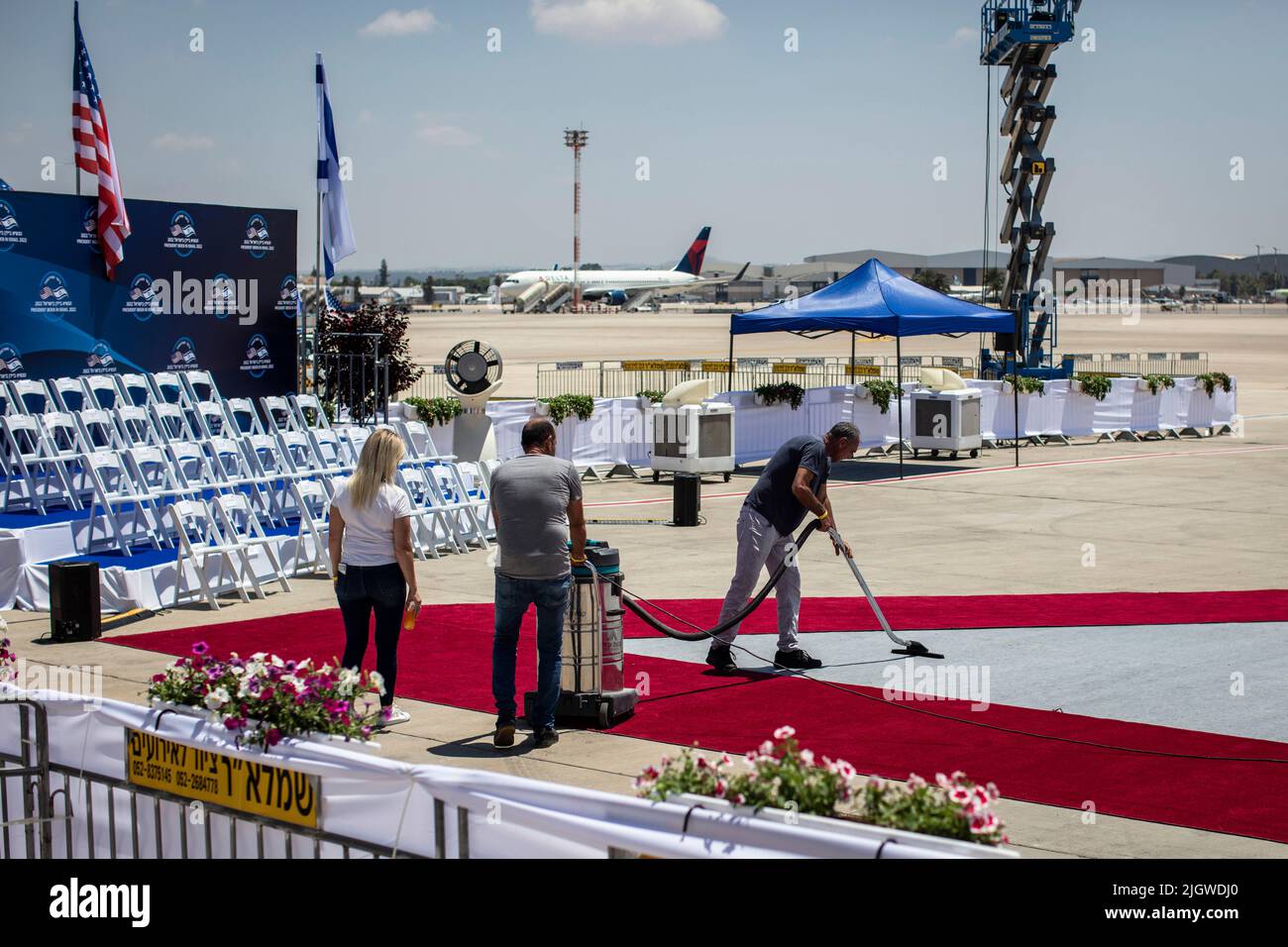 Lod, Israel. 13th July, 2022. Workers sweep a red carpet at Ben Gurion airport ahead of the arrival of US President Joe Biden for the state visit to Israel. Credit: Ilia Yefimovich/dpa/Alamy Live News Stock Photo