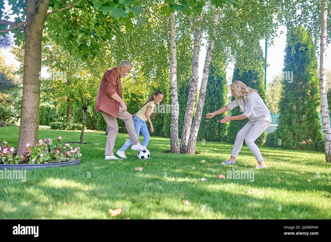 Happy family playing football in the park Stock Photo - Alamy