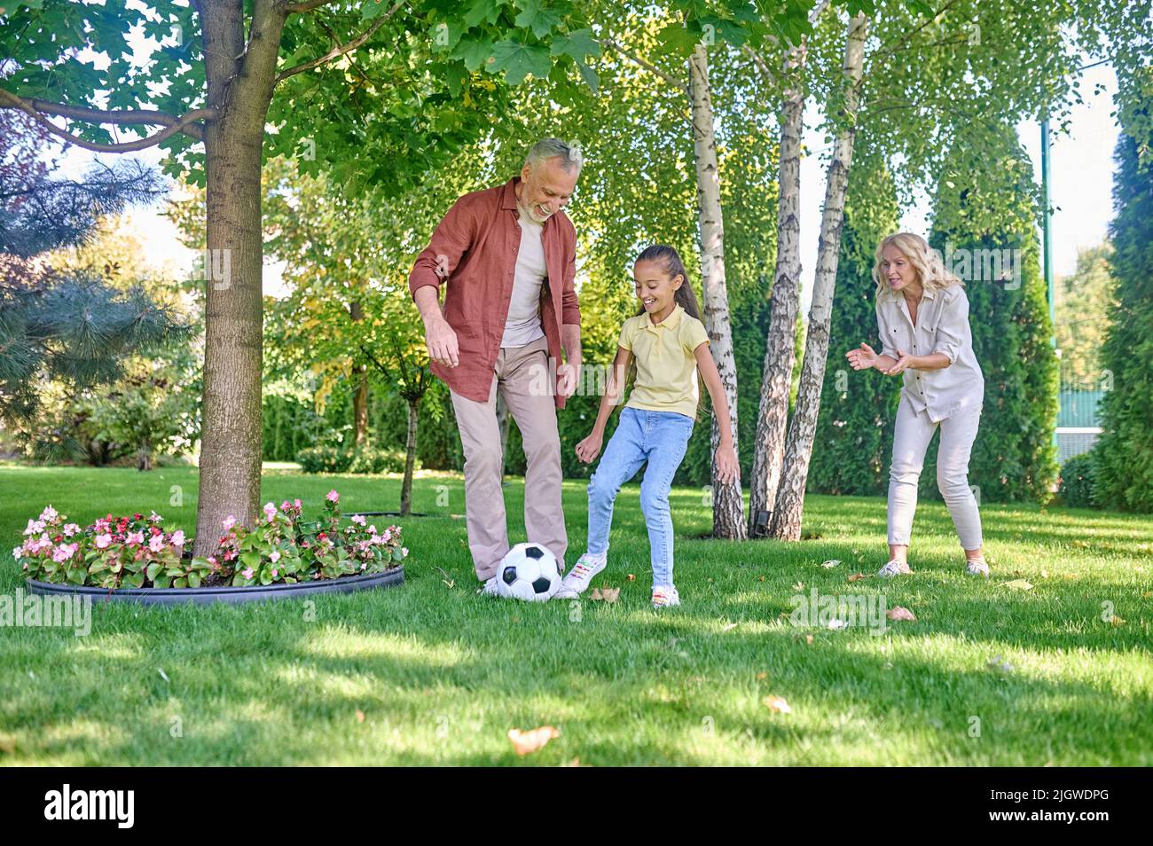 Happy family playing football in the park Stock Photo - Alamy