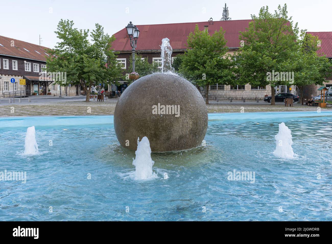 Kolasin, Montenegro - 5 July 2022: Water jets in the summer in the city. Splashing fountain on a sunny day. Stock Photo