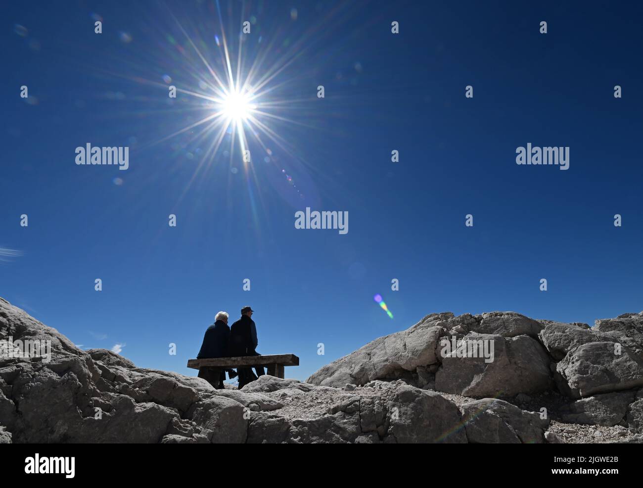 Grainau, Germany. 13th July, 2022. Vacationers enjoy the sun on the Zugspitzplatt. The warm temperatures put a strain on the remnant glacier of the Northern Schneeferner on the Zugspitze this summer. Credit: Angelika Warmuth/dpa/Alamy Live News Stock Photo