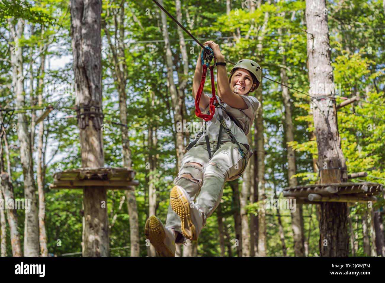 Happy women girl female gliding climbing in extreme road trolley