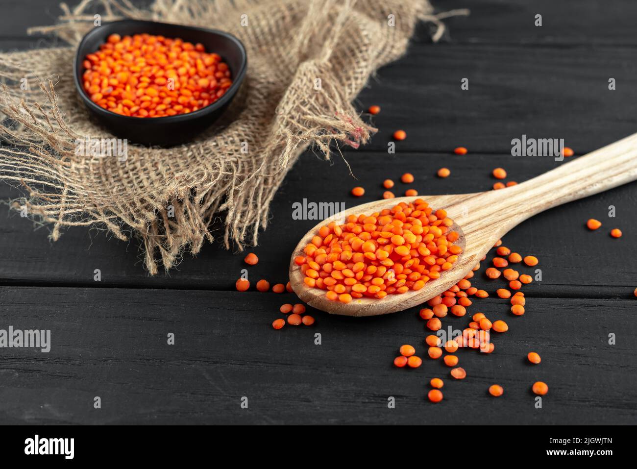 Superfood. Healthy, gluten-free meals. Lentils on a wooden spoon on a rustic dark wooden background Stock Photo