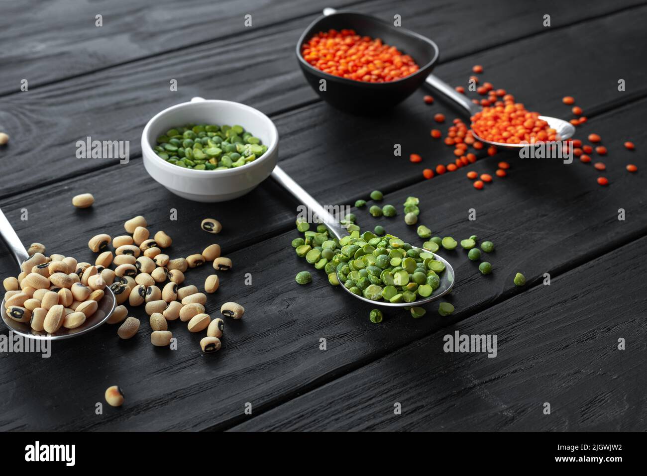 A set of useful Ancient grain foods on spoons on a dark background. An alternative to basic cereals. Stock Photo