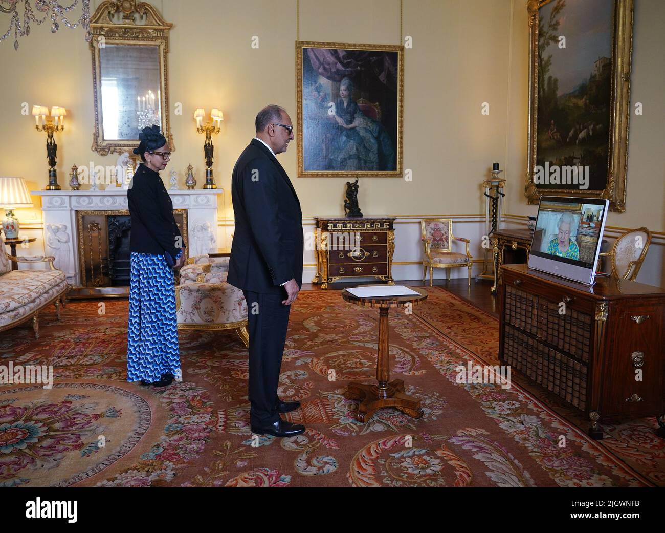 Queen Elizabeth II, in residence at Windsor Castle, appears on a screen via videolink, during a virtual audience to receive Dr. Rajendra Singh, High Commissioner for the Co-operative Republic of Guyana, and his wife Shakuntala Singh, at Buckingham Palace, London. Picture date: Wednesday July 13, 2022. Stock Photo