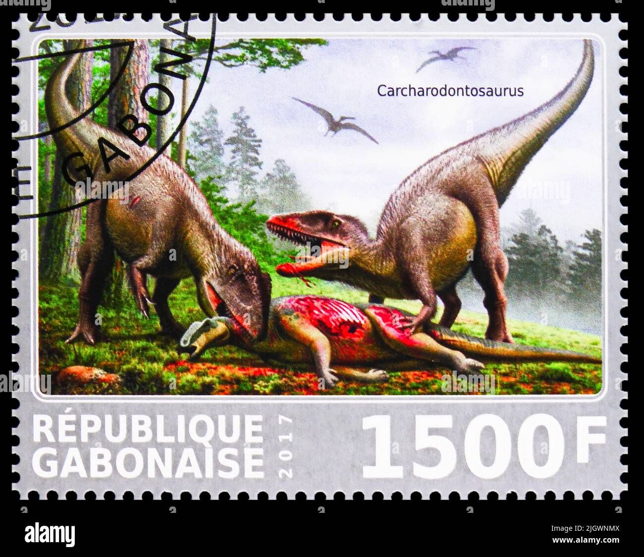 MOSCOW, RUSSIA - JUNE 17, 2022: Postage stamp printed in Gabon shows Carcharodontosaurus eating, Dinosaurs serie, circa 2017 Stock Photo