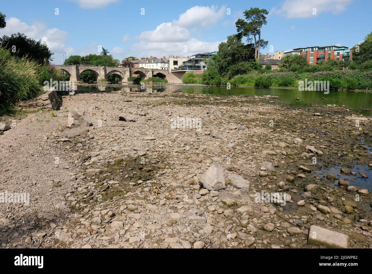River Wye, Hereford, Herefordshire, UK – Wednesday 13th July 2022 – The river level on the River Wye as it passes through the city of Hereford is very low exposing parts of the riverbed. The Environment Agency river level gauge in the city recorded a value of less than 10cm today. The river water temperature was recorded at 20c yesterday posing a threat to fish in the river.  The local weather forecast shows no rain in the next week during a prolonged hot dry spell. Photo Steven May / Alamy Live News Stock Photo