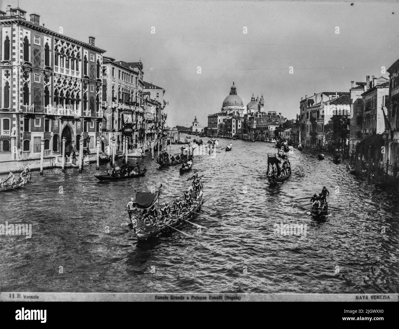 A view of the Grand Canal and of the Maria della Salute church from the bridge of Accademia during a regatta made by Carlo Naya between 1868 and 1882. The historical archive of Naya-Bohm is an archive of 25000 glass plates, now digitalized, of pictures of Venice from 1868 until 1882 (Carlo Naya), and then until 1950 (Bohm). Stock Photo