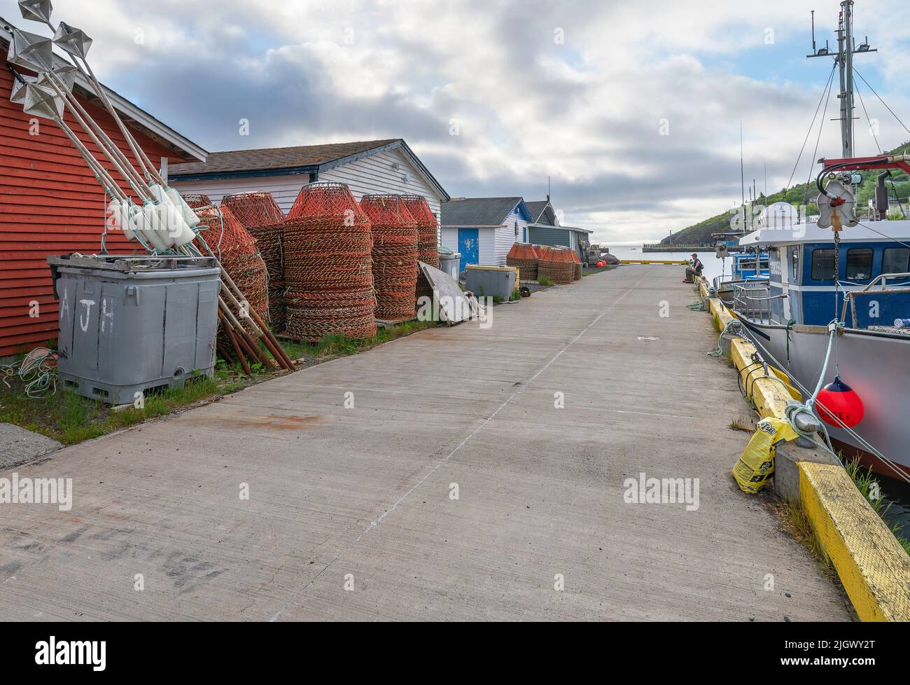 Petty Harbour, Newfoundland and Labrador, Canada June 24, 2022 A lone man sits on the fishing