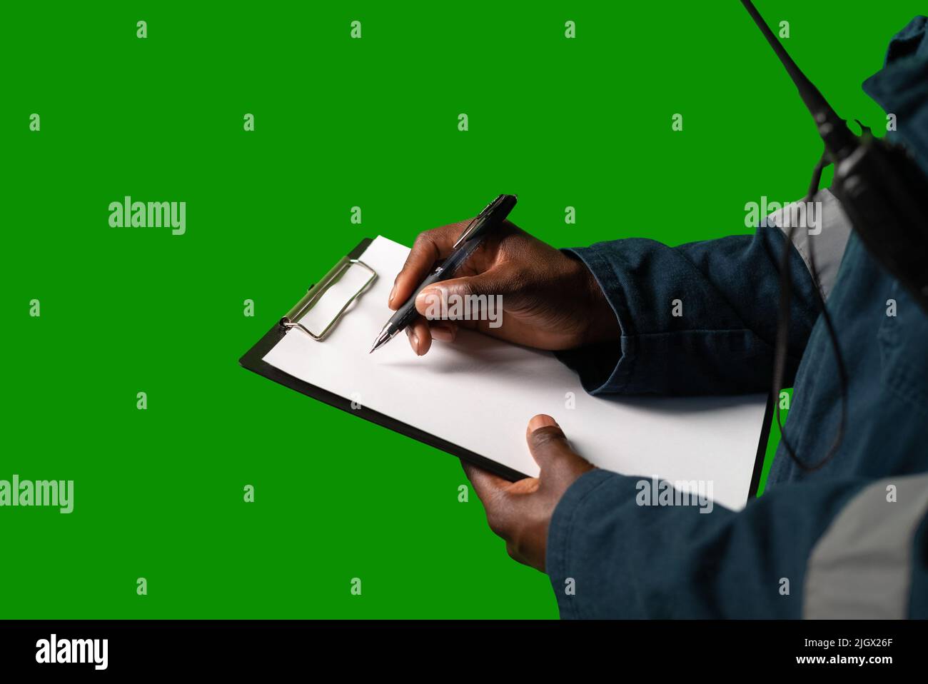 Crop seafarer making notes on clipboard Stock Photo