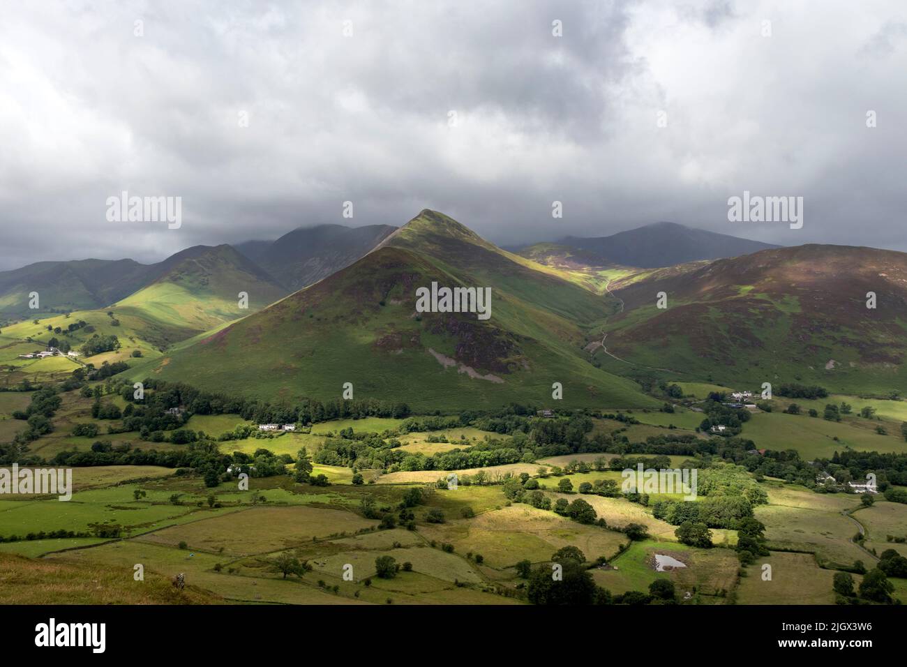 The view towards Causey Pike from Cat Bells over sunlit fields, Lake District, Cumbria, UK Stock Photo
