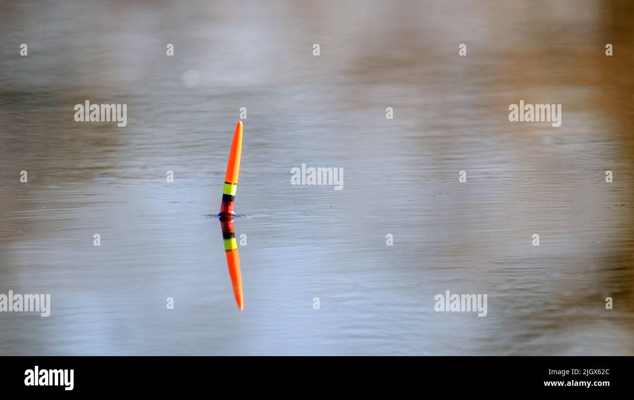 Fishing float on the surface of the water Stock Photo