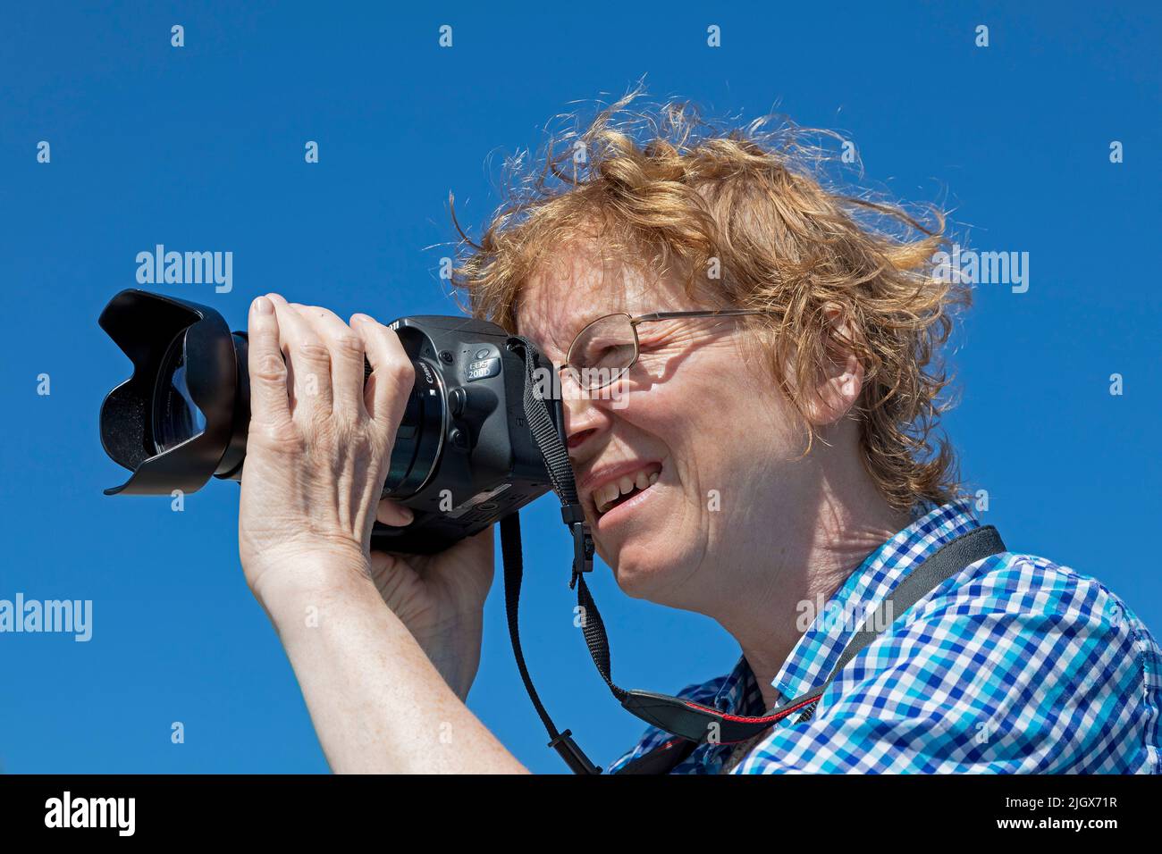 Woman taking photos, Wustrow, Mecklenburg-West Pomerania, Germany Stock Photo