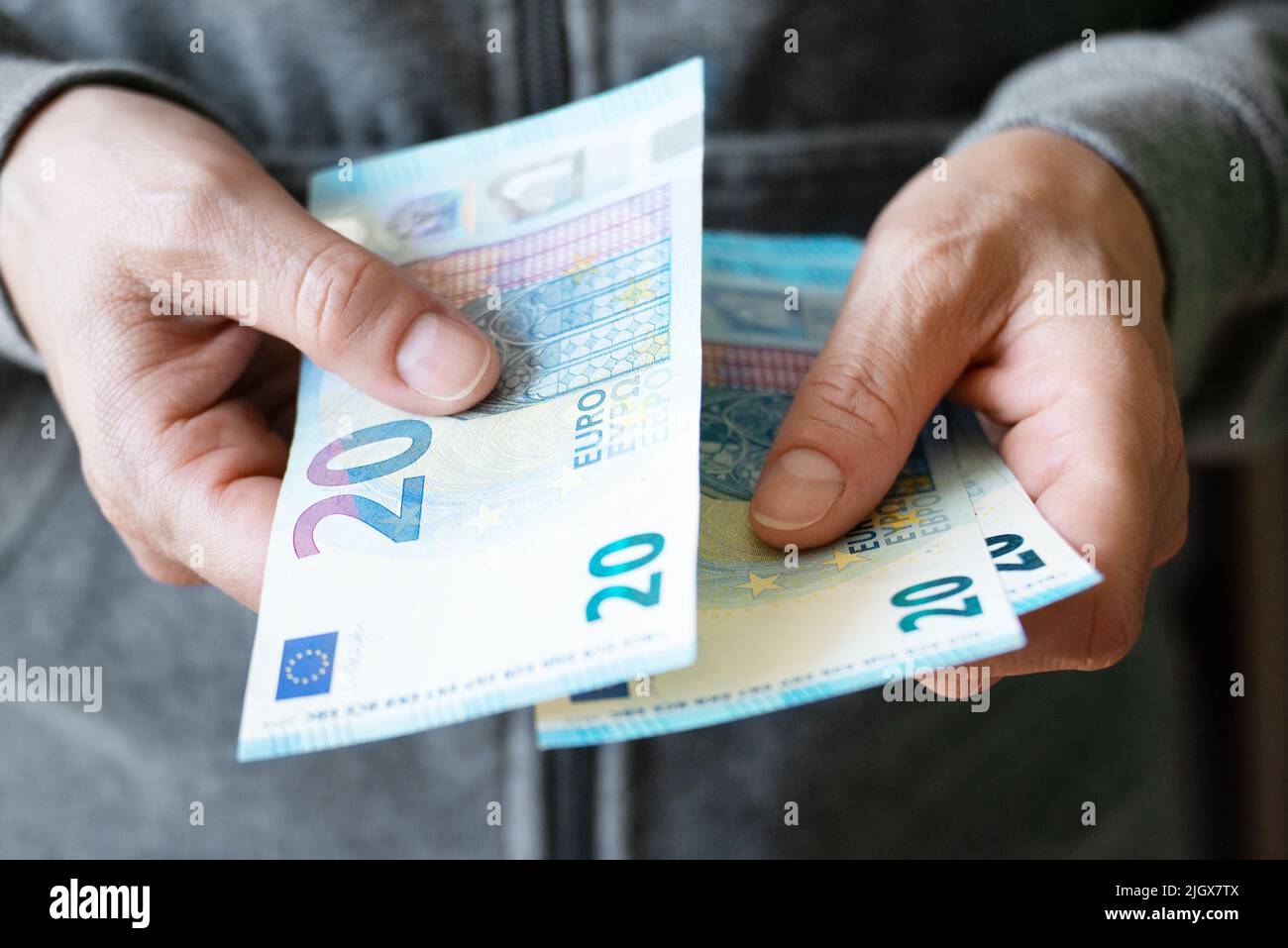Euro money twenty bills closeup in white female hands Stock Photo