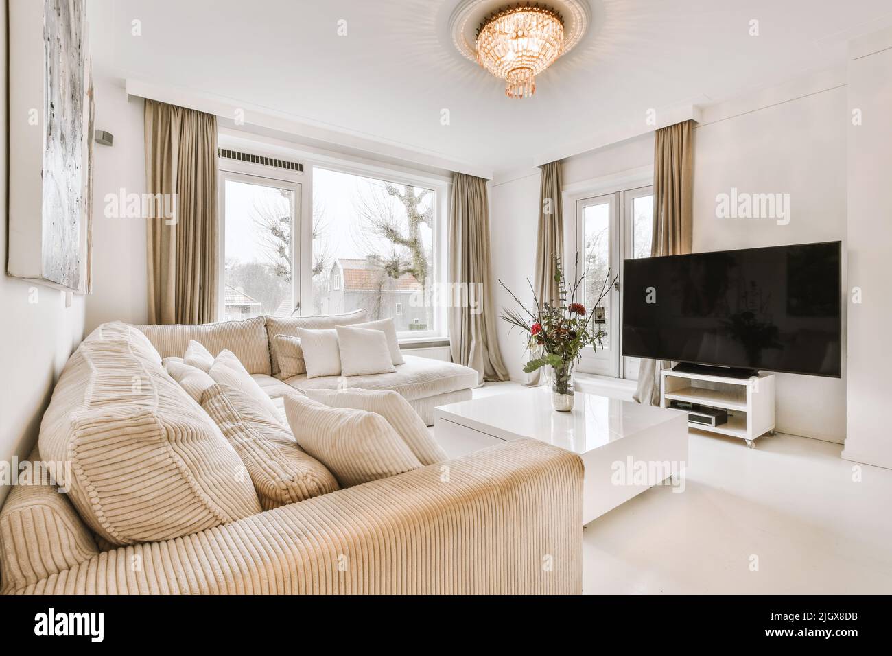 Interior of stylish living room with comfortable sofa and armchairs