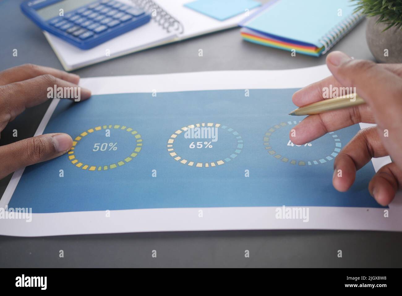 man hand with pen analyzing financial data pov  Stock Photo