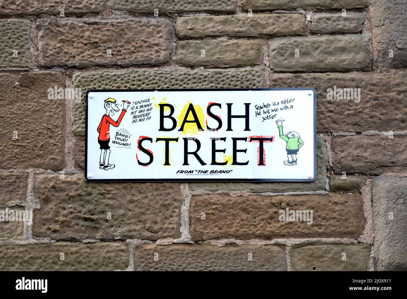 Street name sign for Bash Street in Dundee. Featuring the Bash Street Kids from the Beano comic produced in Dundee by D. C. Thomson. Stock Photo